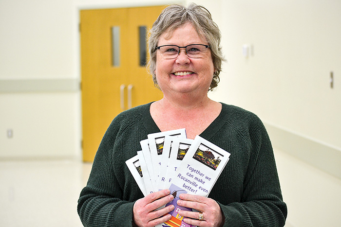 REDO board member Deb Selby with brochures that were handed out at the meeting.<br />
